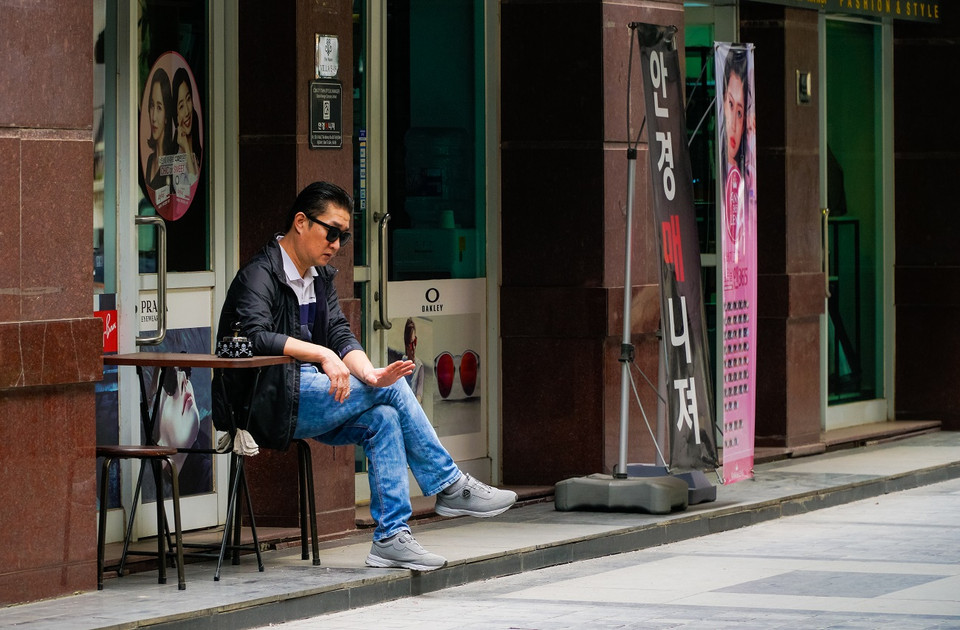 Một vài người Hàn Quốc vẫn ngồi uống càphê đường phố sinh hoạt như những ngày thường. (Ảnh: Minh Hiếu/Vietnam+)