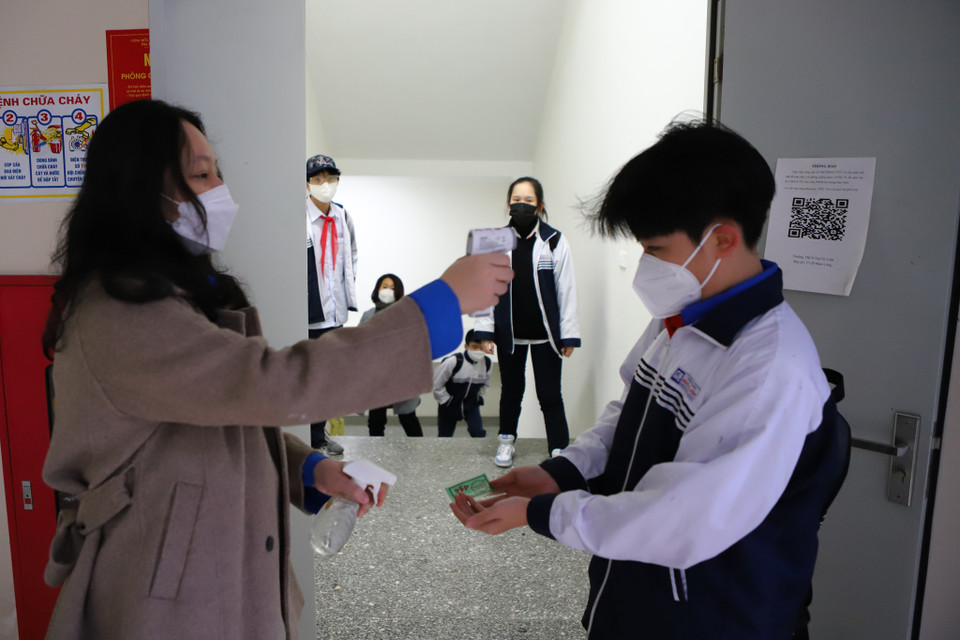 Bên cạnh đó, tại khu vực cửa tầng hầm gửi xe, nhà trường cũng bố trí nhân lực để đo thân nhiệt và khử khuẩn cho các học sinh di chuyển bằng phương tiện cá nhân. (Ảnh: Hoài Nam/Vietnam+)