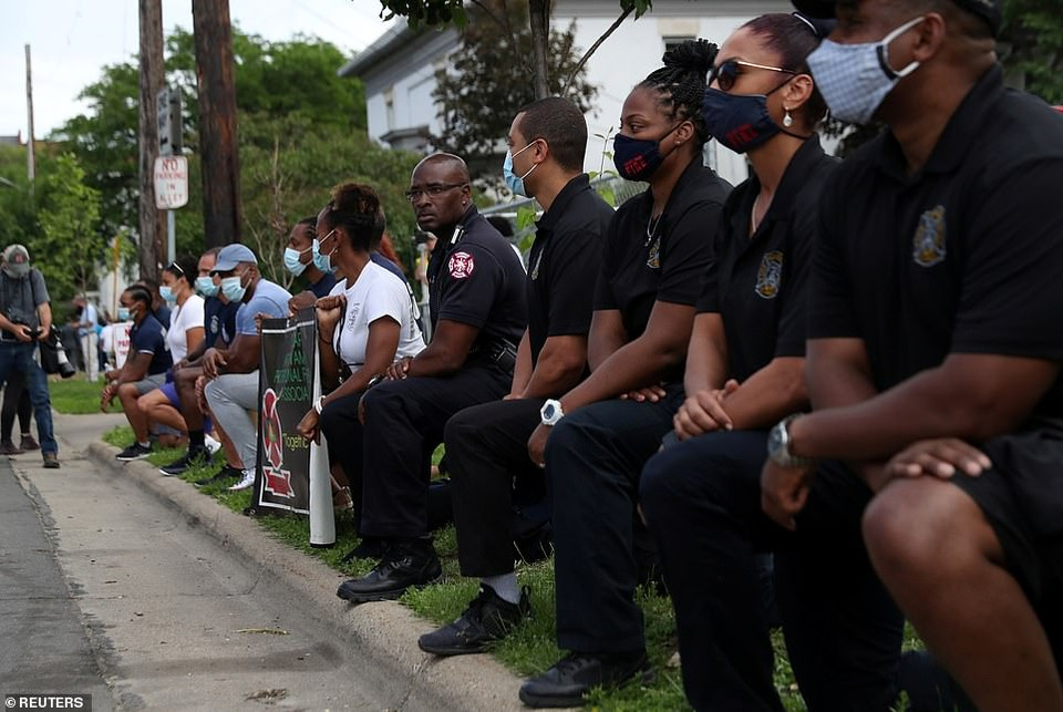 Lực lược cảnh sát Minneapolis quỳ gối trước di hài của George Floyd. (Nguồn: Reuters)