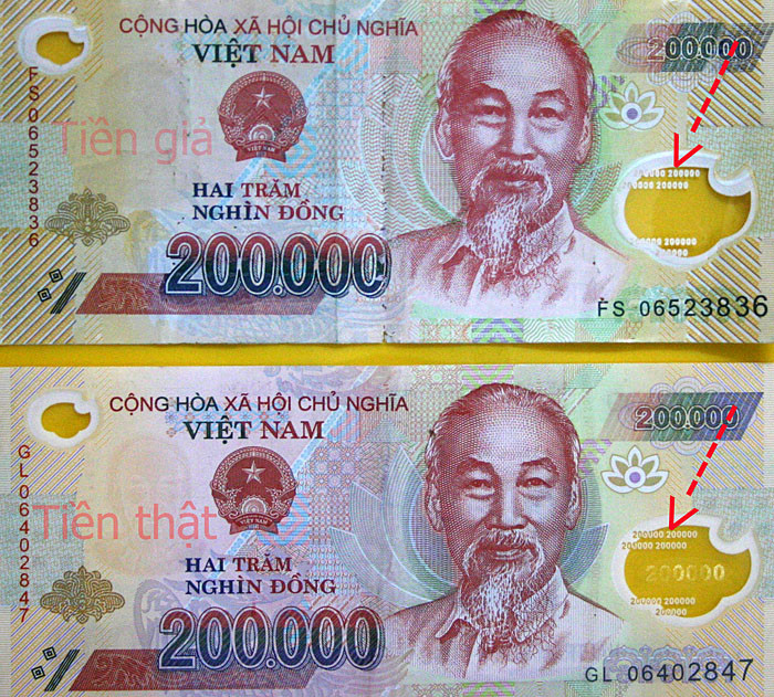 Tiền thật và tiền giả mệnh giá 200.000 đồng. (Nguồn: Công an Kiên Giang)