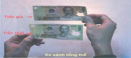 So sáng tiền thật và tiền giả tờ 100.000 đồng. (Nguồn: Ngân hàng Nhà nước)