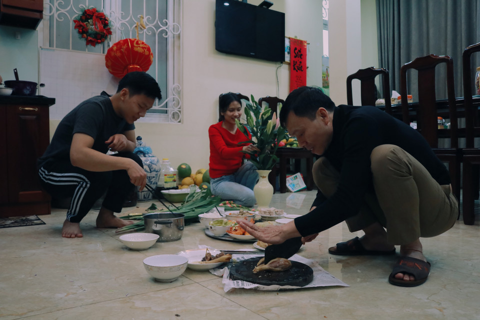 Ở nhà, các con của chị Thuỷ - anh Tuấn Sang và chị Thu Trang tất bật bày biện cỗ cúng. Anh Sang cho biết, từ ngày được nghỉ Lễ hai anh chị đã sắp xếp thời gian ở nhà để dọn dẹp nhà cửa và chuẩn bị lễ cúng cùng bố mẹ. (Ảnh: Minh Hiếu/Vietnam+)