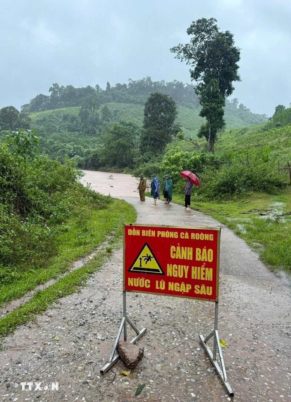 Lực lượng chức năng thiết lập cảnh báo, chốt chặn, tuyên truyền và ngăn chặn người dân không lưu thông qua khu vực nguy hiểm. (Ảnh: TTXVN phát)