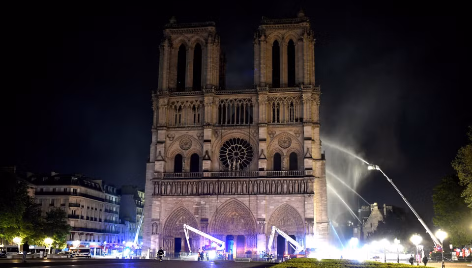 Lính cứu hỏa nỗ lực dập lửa tại hiện trường vụ cháy Nhà thờ Đức Bà ở Paris, Pháp ngày 15/4/2019. (Ảnh: AFP/TTXVN)