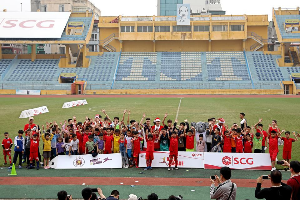 Các cầu thủ chụp ảnh chung với các em nhỏ.