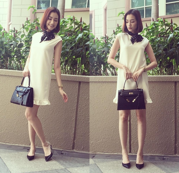 Trúc Diễm hóa nàng tiểu thư duyên dáng với đầm trắng dáng suông cùng điểm nhấn là khăn nhỏ buộc cổ.