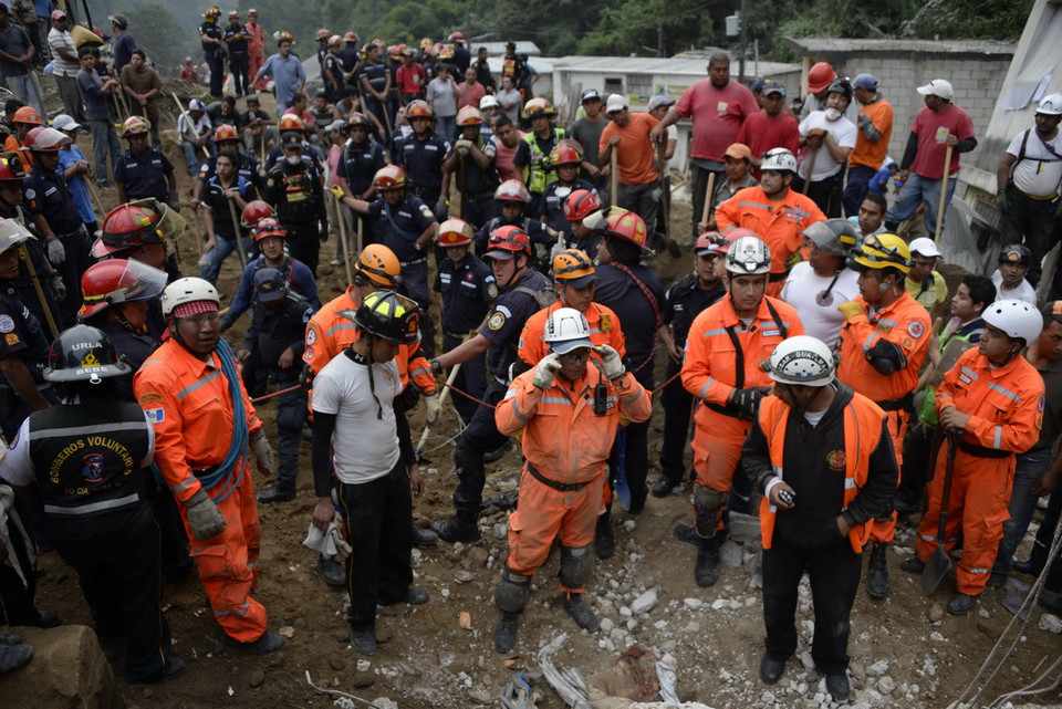 Lực lượng cứu hộ nỗ lực tham gia tìm kiếm người mất tích sau vụ lở đất tại làng El Cambray ngày 2/10. (AFP/ TTXVN)