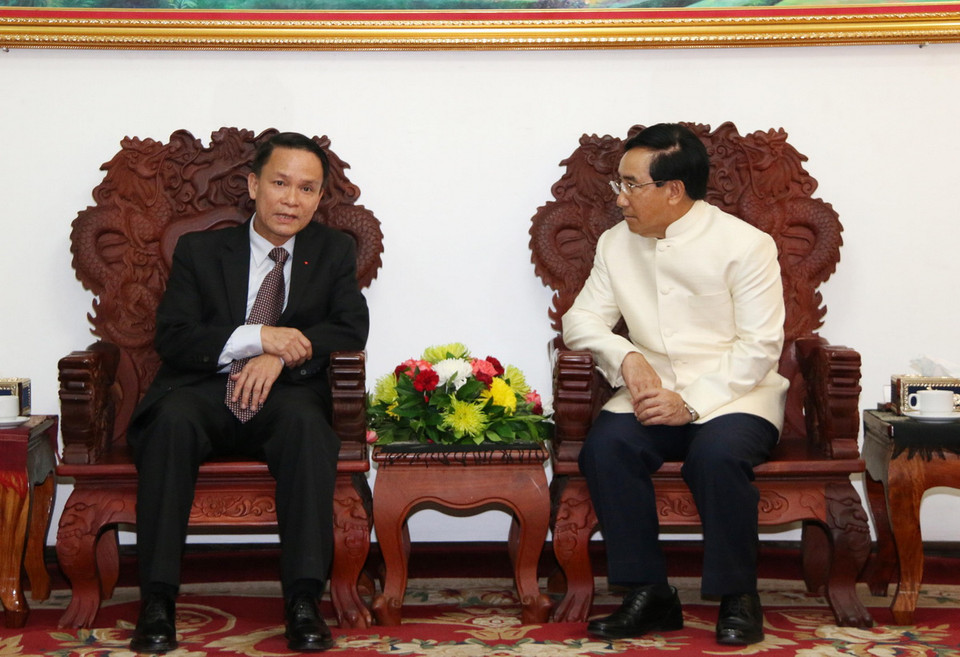 Tổng Giám đốc TTXVN Nguyễn Đức Lợi cùng Ủy viên Bộ Chính trị, Phó Thủ tướng Chính phủ Lào Phankham Viphavan. (Ảnh: Phạm Kiên/TTXVN)