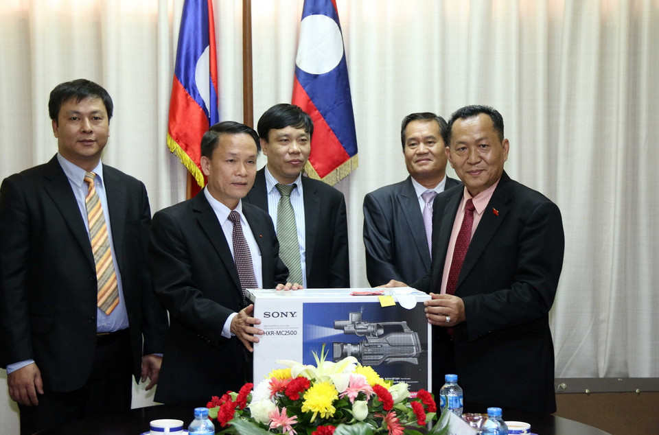  Tổng Giám đốc TTXVN Nguyễn Đức Lợi trao tặng Tổng Giám đốc KPL Sounthone Khanthavong một số trang thiết bị kỹ thuật. (Ảnh: Phạm Kiên/TTXVN) 