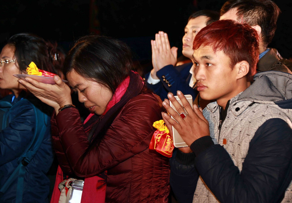 Du khách tham gia lễ phát lương tại đền Trần Thương. (Ảnh: TTXVN)