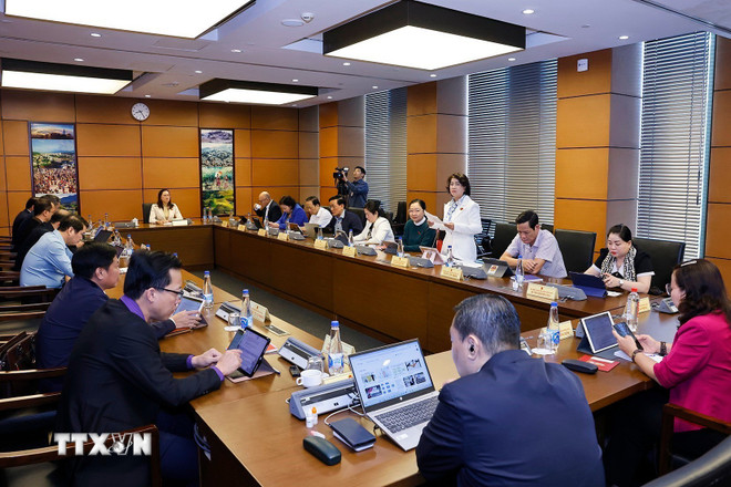 Delegace Národního shromáždění z provincií Vinh Long a Son La diskutují ve skupinách. (Foto: Doan Tan/VNA) ttxvn-quoc-hoi-thao-luan-o-to-ve-4-luat-2.jpg