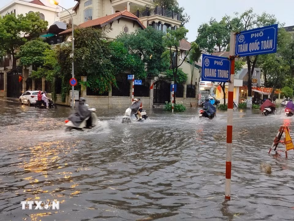 Nước ngập sâu tại ngã tư Trần Quốc Toản-Quang Trung. (Ảnh: Hoàng Hiếu/TTXVN)