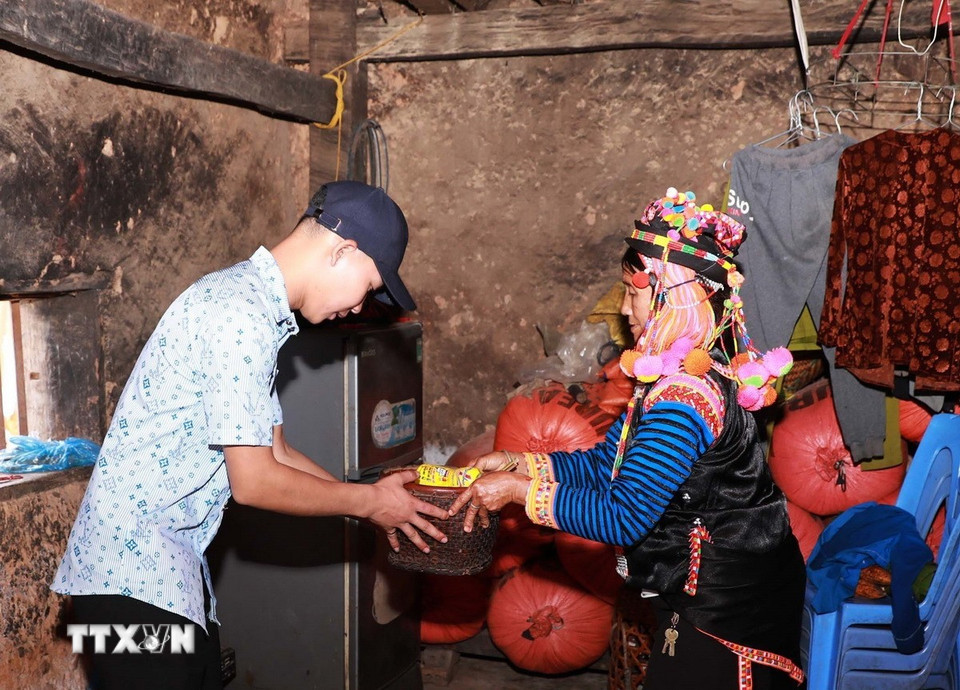 ពេលជូនឬទទួលអំណោយ កូនចៅត្រូវឱនក្បាលដោយគួរសម ដើម្បីបង្ហាញការគោរពចំពោះឪពុកម្ដាយ។ (រូបថត៖ Quy Trung/VNA)