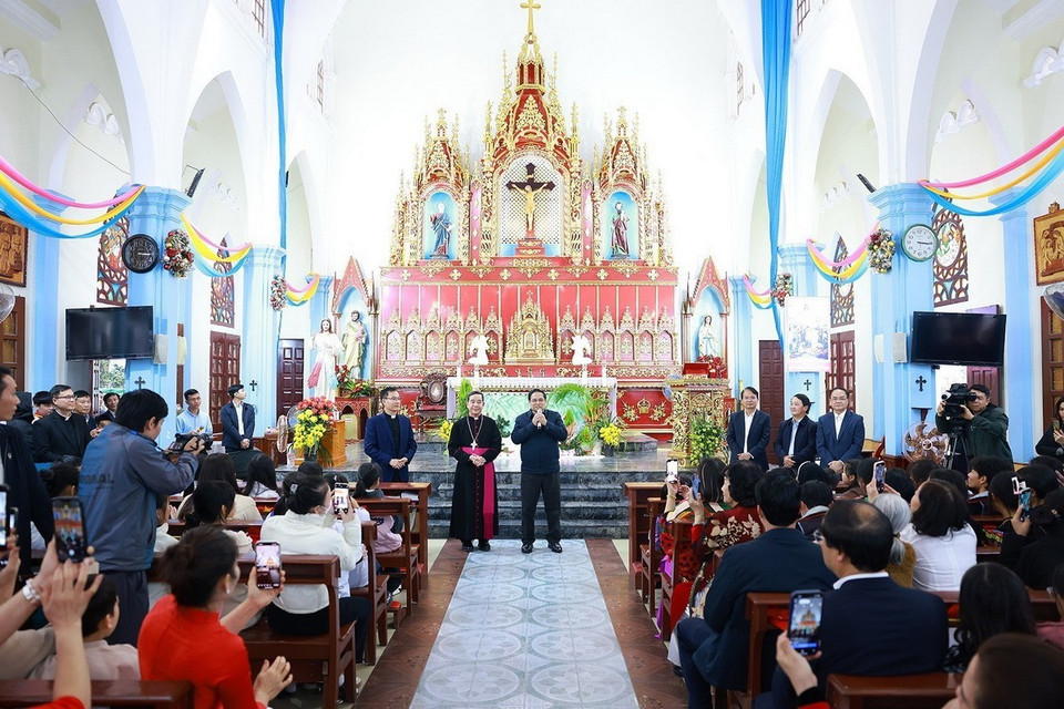 Thủ tướng Phạm Minh Chính chúc mừng Giám mục Giáo phận Hưng Hóa Hoàng Minh Tiến và các chức sắc, chức việc và giáo dân Giáo xứ Lào Cai. (Ảnh: Dương Giang/TTXVN)