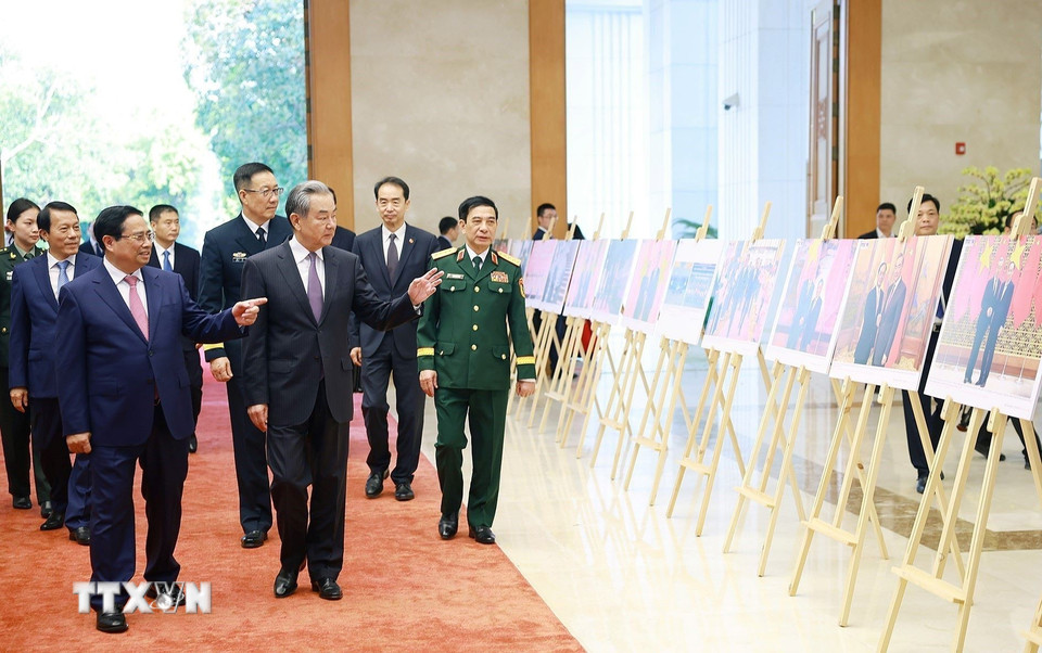 Thủ tướng Phạm Minh Chính và Bộ trưởng Ngoại giao, Quốc phòng, Công an Trung Quốc tham quan trưng bày ảnh về quan hệ hợp tác giữa hai nước Việt Nam-Trung Quốc do Thông tấn xã Việt Nam thực hiện. (Ảnh: Dương Giang/TTXVN)