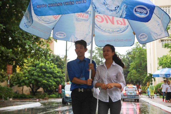 Sinh viên tình nguyện dùng ô to đưa sĩ tử thoát cơn mưa rào ảnh 19