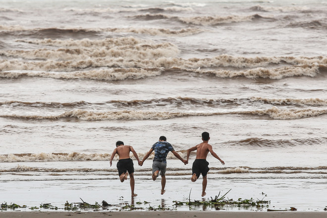 Bất chấp lệnh cấm tắm, du khách đổ xô bơi biển "đón" bão số 2 ảnh 5