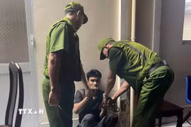 Đối tượng Nhớ bị khống chế trong lúc đột nhập trái phép vào trụ sở Khối Cảnh sát. (Ảnh: TTXVN phát)