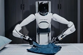 Một người đàn ông điều khiển robot Agibot. (Nguồn: AFP)