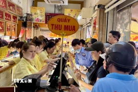 Nhiều người dân vẫn đổ xô mua vào bất chấp giá vàng đang neo ở mức cao. (Ảnh: Hứa Chung/TTXVN)