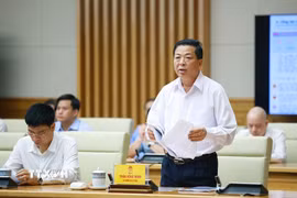 Bộ trưởng Bộ Xây dựng Trần Hồng Minh báo cáo kết quả thực hiện nhiệm vụ của ngành xây dựng. (Ảnh: Dương Giang/TTXVN)