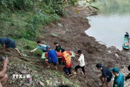 Lực lượng cứu hộ đã tìm thấy thi thể 2 cháu trai bị đuối nước. (Ảnh: TTXVN phát)