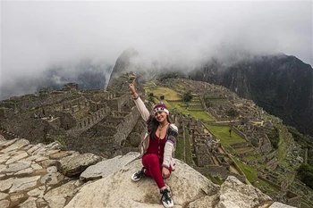 Khách du lịch chụp ảnh lưu niệm tại Thành cổ Machu Picchu thuộc tỉnh Cusco, Peru ngày 2/11/2020. (Ảnh: AFP/TTXVN)