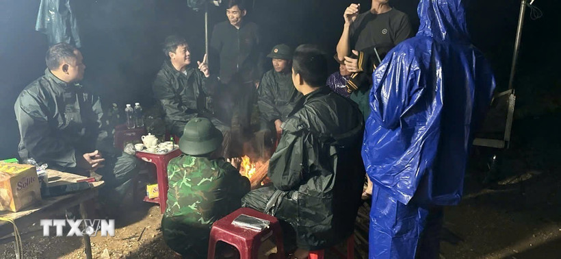 Các lực lượng chức năng đang bàn bạc phương án tìm kiếm em N.Đ.H. (Nguồn: TTXVN phát)