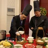 Quan chức ngoại giao tại Trung Quốc trải nghiệm cách chế biến một tô phở. (Ảnh: Hải Yến/TTXVN)