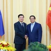 Thủ tướng Phạm Minh Chính hội kiến Tổng Bí thư, Chủ tịch nước Lào Thongloun Sisoulith. (Ảnh: Dương Giang/TTXVN)