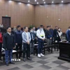 Các bị cáo tại phiên toà xét xử sáng 24/12. (Ảnh: Phạm Kiên/TTXVN)