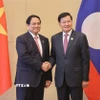 Thủ tướng Phạm Minh Chính gặp Tổng Bí thư, Chủ tịch nước Lào Thongloun Sisoulith. (Ảnh: Dương Giang/TTXVN)