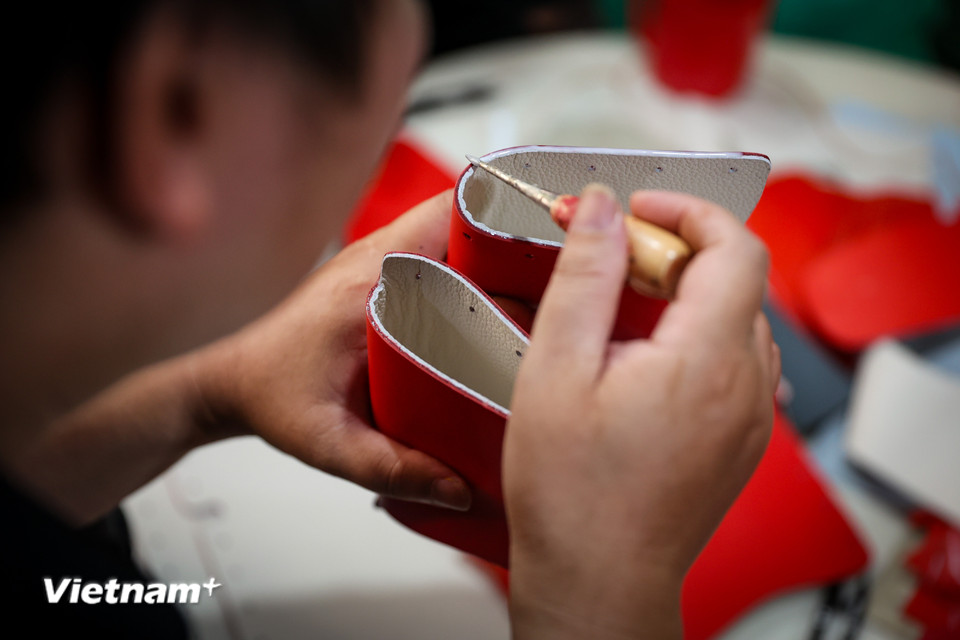 Xưởng may không chỉ mang đến cho khách hàng những sản phẩm chất lượng cao mà thông qua các sản phẩm này, những người yếu thế có dịp bày tỏ tinh thần yêu nước. (Ảnh: Hoài Nam/Vietnam+)