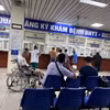 Người dân làm thủ tục khám chữa bệnh bảo hiểm y tế. (Ảnh: PV/Vietnam+)