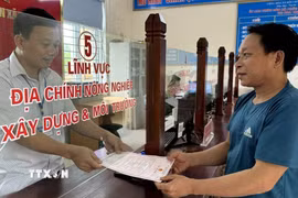 Người dân làm thủ tục hành chính tại bộ phận một cửa xã Phúc Thịnh, huyện Ngọc Lặc phấn khởi nhận kết quả. (Ảnh: TTXVN phát)