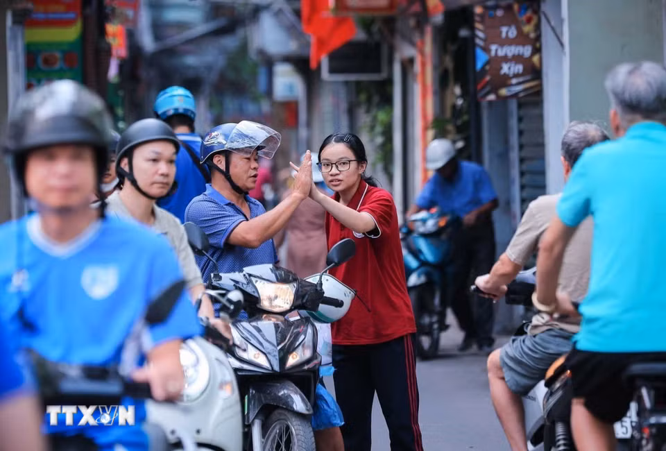 Chúc con hoàn thành tốt môn thi cuối Kỳ thi tuyển sinh lớp 10 công lập tại Hà Nội. (Ảnh: Hoàng Hiếu/TTXVN)