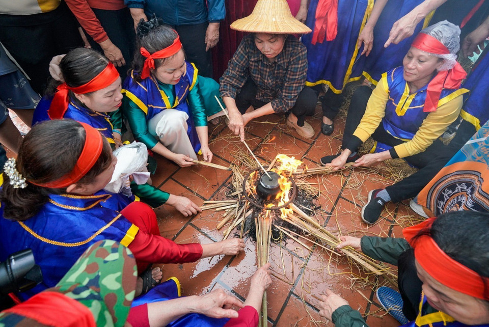 Phần thi thổi cơm của các đội thi diễn ra trong sân đình Thị Cấm. (Ảnh: Khánh Hòa/TTXVN)