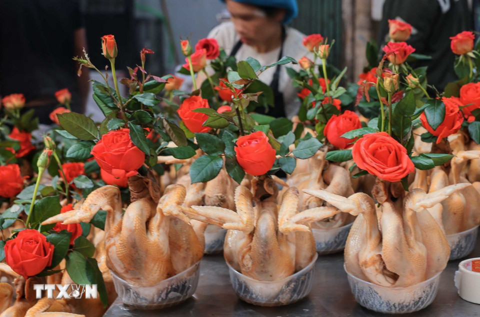 Chuẩn bị gà ngậm hoa sen, buộc cánh tiên tại chợ Hàng Bè trong phiên chợ cuối năm. (Ảnh: Hoàng Hiếu/TTXVN)
