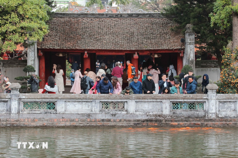 Nhiều du khách trong nước và quốc tế đến thăm Văn Miếu-Quốc Tử Giám trong ngày cuối cùng năm Giáp Thìn. (Ảnh: Hoàng Hiếu/ TTXVN)