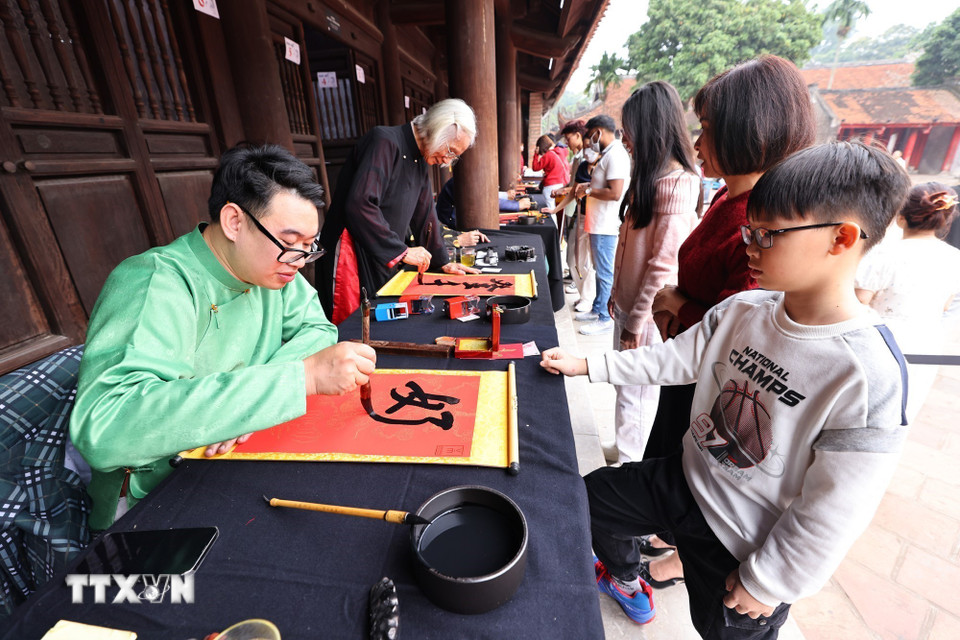 Người dân thủ đô xin chữ đầu năm tại Văn Miếu-Quốc Tử Giám (Hà Nội) là nét văn hóa truyền thống đặc sắc để cầu may mắn, trí tuệ và bình an. (Ảnh: Minh Đức/TTXVN)