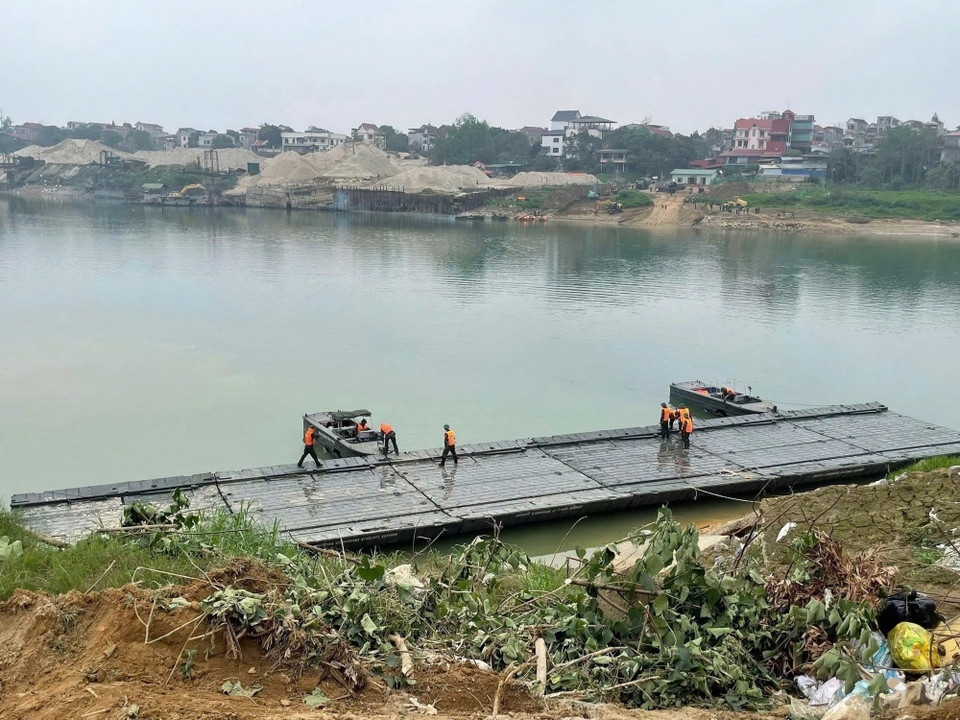 Các lực lượng quân đội đang khẩn trương thi công lắp đặt cầu phao qua sông Lô phục vụ nhân dân đón Tết Nguyên đán 2026. (Ảnh: Nguyễn Văn Cảnh/TTXVN)