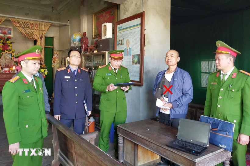 Cơ quan Cảnh sát điều tra Công an tỉnh thi hành lệnh bắt bị can Lê Minh Vũ. (Ảnh: TTXVN phát)