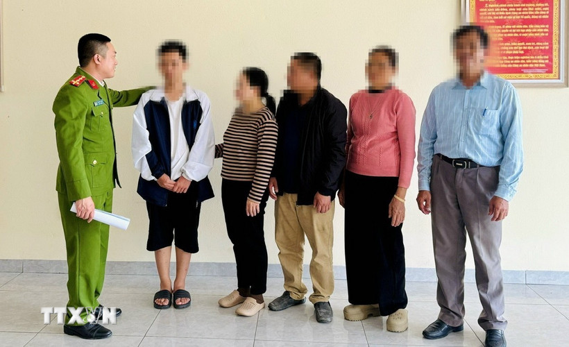 Công an phường Phú Bài (Công an thành phố Huế) bàn giao nạn nhân cho gia đình. (Ảnh: TTXVN phát)