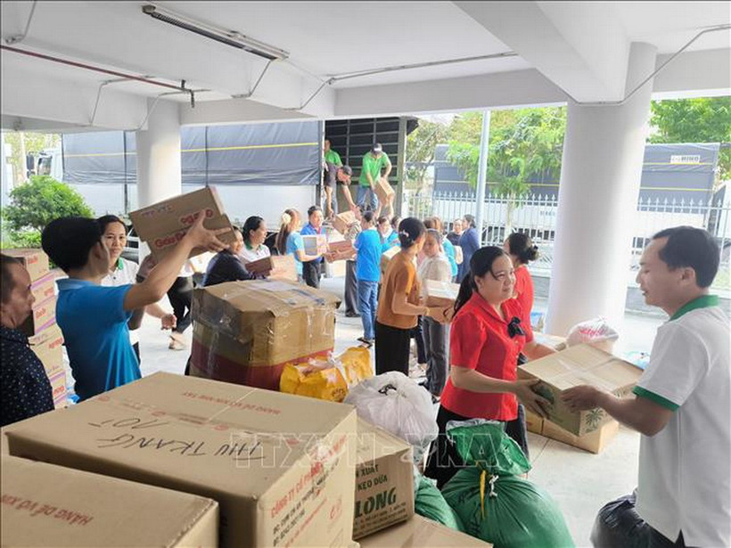 Vận chuyển hàng hóa cứu trợ lên xe chuyển ra miền Trung, Tây Nguyên. (Ảnh: Huỳnh Phúc Hậu/TTXVN)