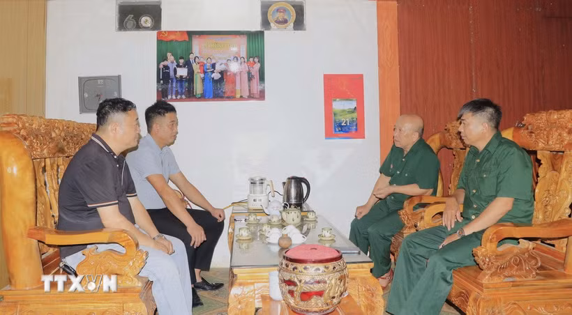 Lãnh đạo Hội Cựu chiến binh xã Hưng Khánh và cán bộ xã thăm thương binh Đào Đức Chỉ, thôn Hồng Hải, xã Hưng Khánh (Lào Cai). (Ảnh: Đinh Thùy/TTXVN)