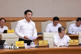 Bộ trưởng Bộ Tài chính Nguyễn Văn Thắng báo cáo tình hình kinh tế-xã hội tháng 9 và 9 tháng năm 2025. (Ảnh: Dương Giang/TTXVN)