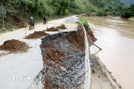 Điểm sạt lở ăn sâu vào tim đường trên Quốc lộ 7, khiến nguy cơ mất đường rất cao. (Ảnh: Văn Tý/TTXVN)