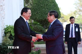 Thủ tướng Phạm Minh Chính gặp Thủ tướng Lào Sonexay Siphandone. (Ảnh: Dương Giang/TTXVN)