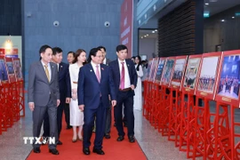 Thủ tướng Phạm Minh Chính tham quan trưng bày ảnh về hoạt động ngoại giao. (Ảnh: Dương Giang/TTXVN)
