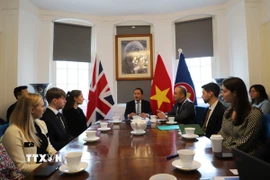 Đại sứ Việt Nam tại Anh Đỗ Minh Hùng (ngồi giữa) phát biểu khai mạc Tọa đàm Hợp tác thương mại-công nghệ Việt Nam-Anh. (Ảnh: Hữu Tiến/TTXVN)